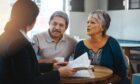 Senior couple talking with lawyer about financial and legal advice