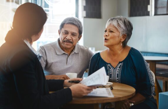 Senior couple talking with lawyer about financial and legal advice