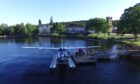 With Cameron House in the background, passengers board a seaplane for a trip around Loch Lomond.