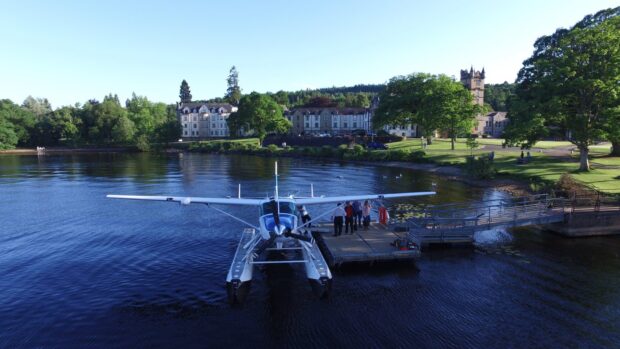 With Cameron House in the background, passengers board a seaplane for a trip around Loch Lomond.