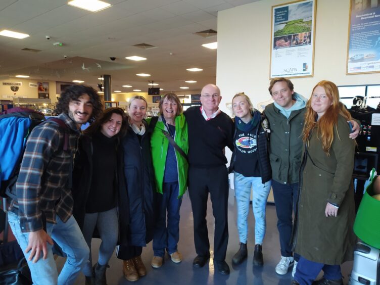 Loganair pilot Colin McAllister, centre, stands next to actress Saoirse Ronan during production of the new film.