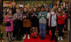 Glasgow writer Angela Proctor promotes the film, which seeks to raise awareness about Scotland’s homeless kids, with children from Knightswood Primary.