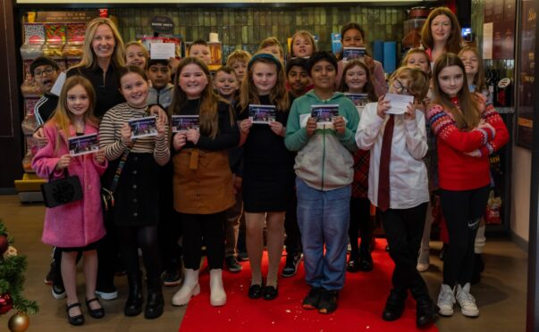 Glasgow writer Angela Proctor promotes the film, which seeks to raise awareness about Scotland’s homeless kids, with children from Knightswood Primary.