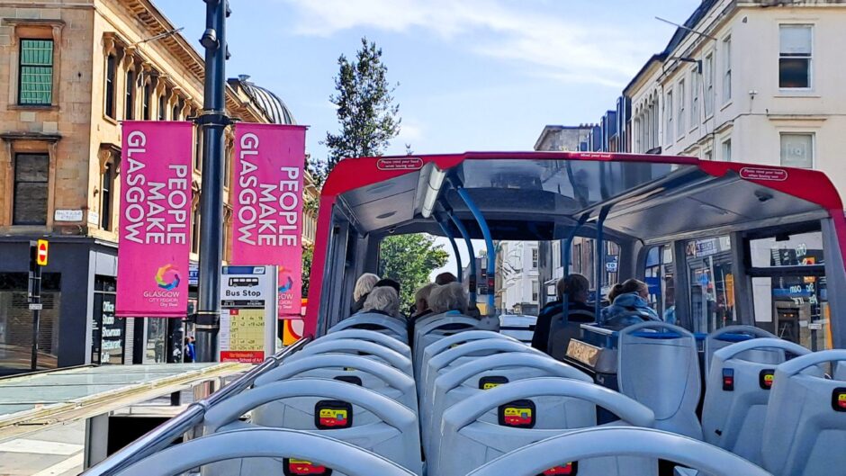 On the open-top bus.