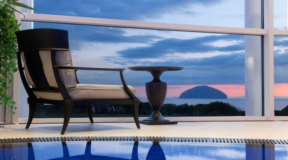 a poolside chair facing the view at Trump Turnberry spa