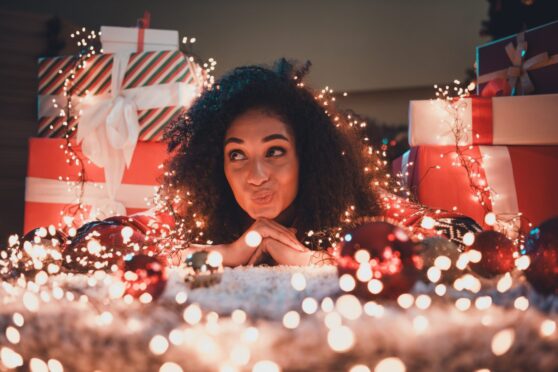 woman poses amid Christmas home décor ideas