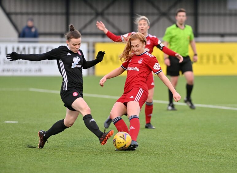 Josi in action against Aberdeen Women at Balmoral Stadium. Aberdeen’s Eilidh Shore in red.