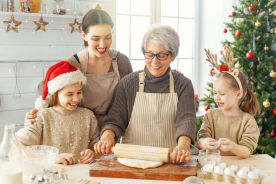 generations of women in a family baking for christmas