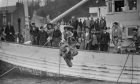 A diver leaps from the deck to join the search for the fabled treasure of the sunken Spanish galleon