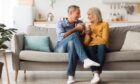 older couple smiling on sofa