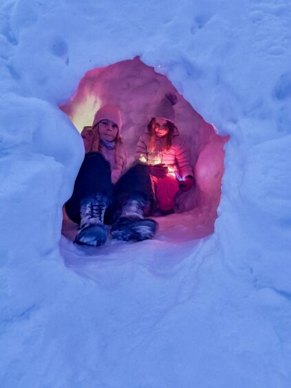 The girls hide out in a snow cave.