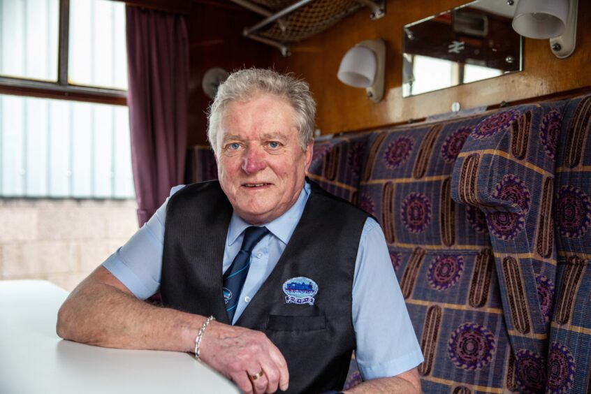 Vice Chairman Jim Paterson in uniform on board a refurbished train.