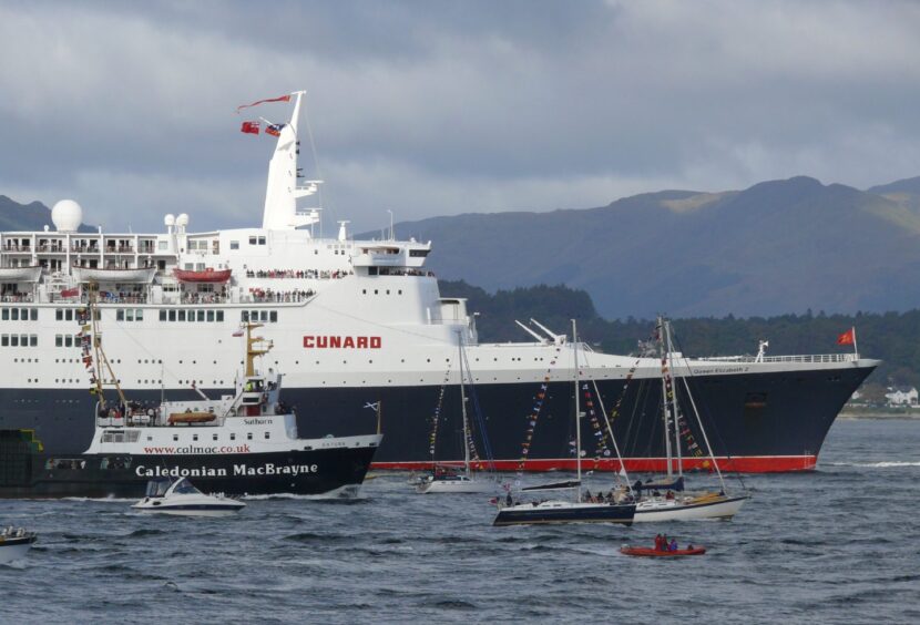 QE2 flanked by a flotilla of ships on its final visit to the Clyde in October 2008.