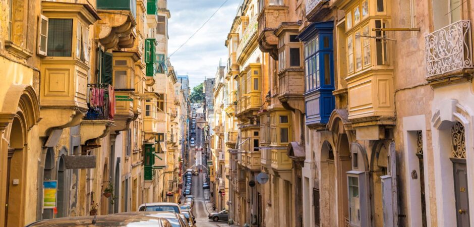 Narrow Street with colourful balconies in historical part of Valletta.