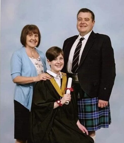 Jessica Herd with her parents on her graduation day.