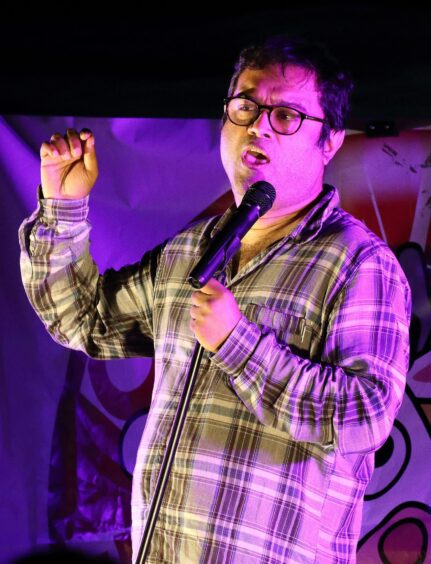 Paul performing stand-up comedy.