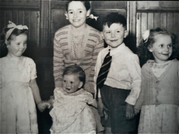 Brian with his sisters and a cousin.