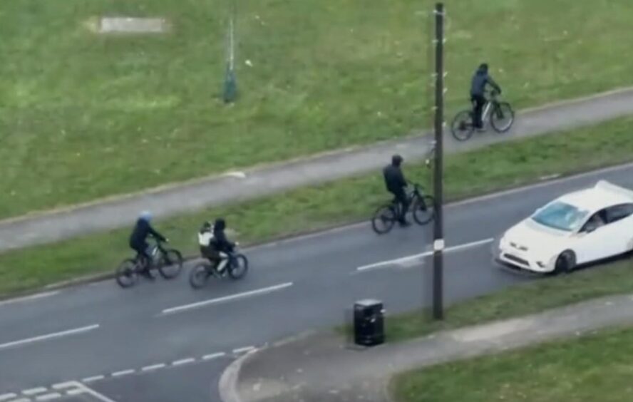Drone image of a gang of e-bikers followed by police in Newport, Wales, with officers moving in.