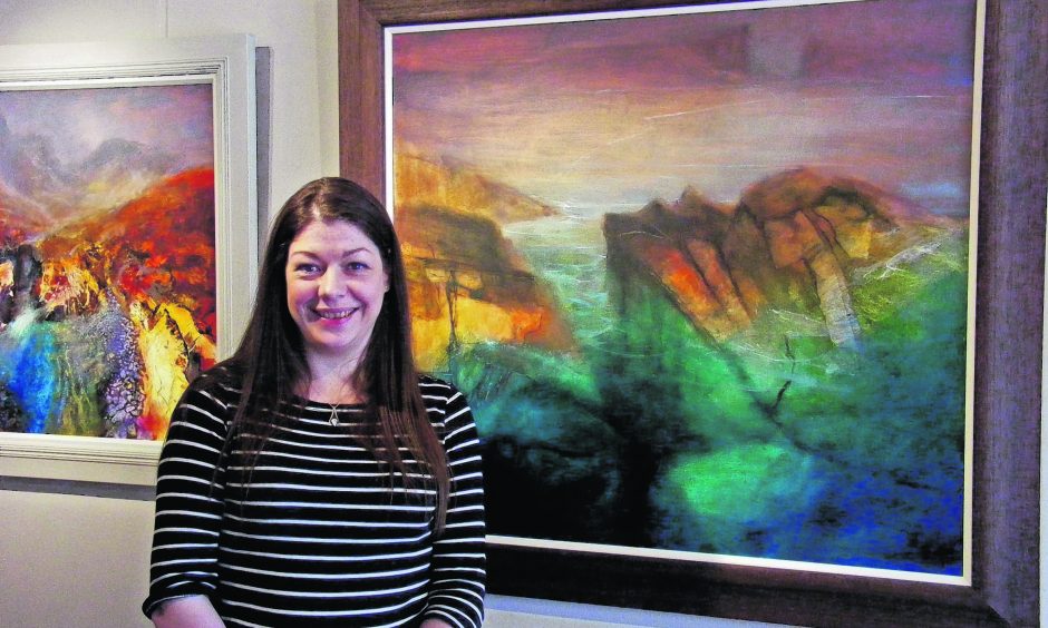 Beth with a painting behind her