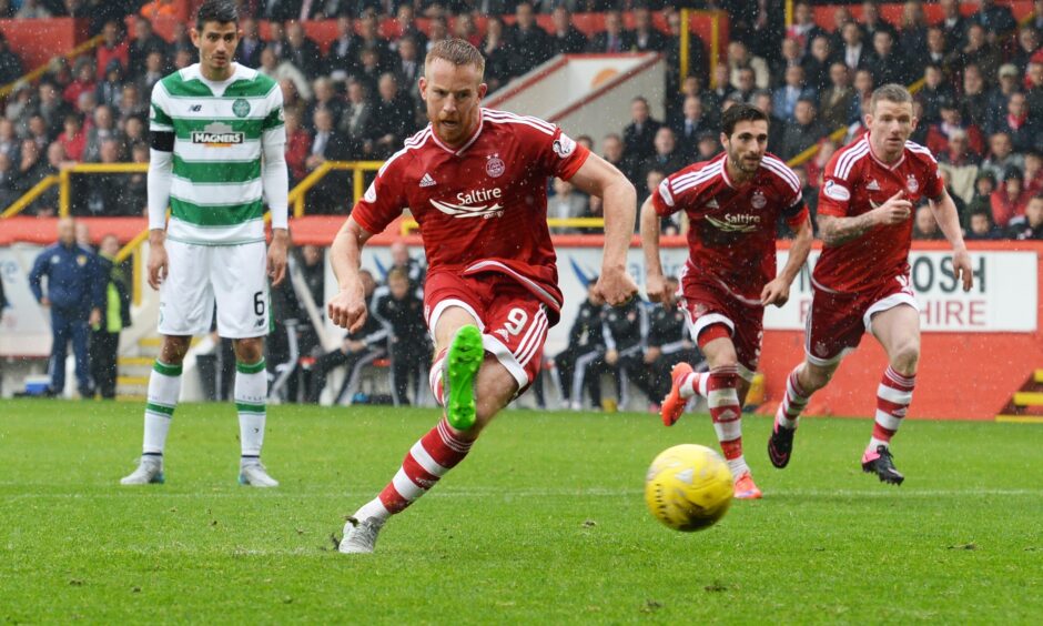 Adam Rooney slots the ball home from the penalty spot to equalise against Celtic.