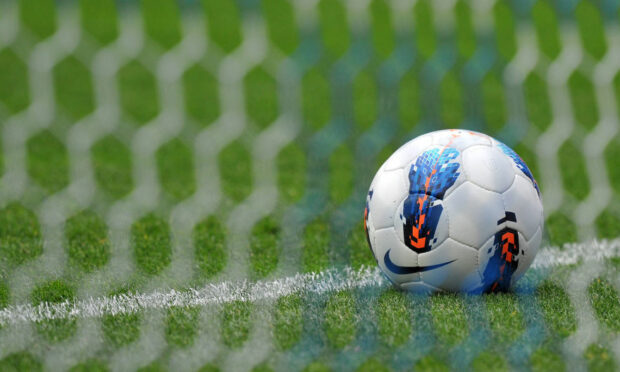 File photo dated 24/09/11 of a football behind a goal net, as the head of the players' union said that as many as seven professional football clubs are now embroiled in the growing child sex abuse scandal, with more than 20 ex-players alleging they were victims.