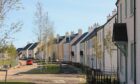 Chapelton of Elsick street with trees and houses.