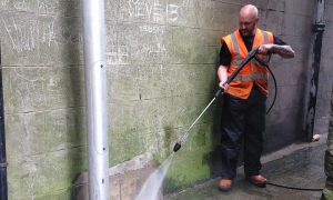 Man cleaning chewing gum.