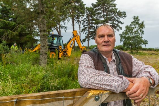 Duncan Brown, owner of Seaview Caravan Park, while the council digger gets to work.