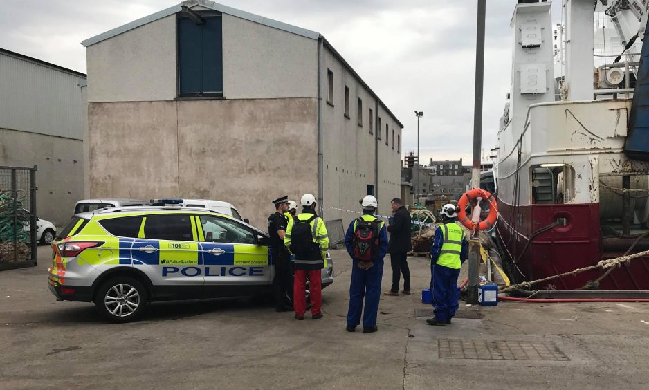 Investigators at the scene of the tragedy in Fraserburgh Harbour.