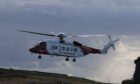 Coastguard helicopter Rescue 900 based in Sumburgh, which was called to the scene to search for the driver who went missing in the Pentland Firth.