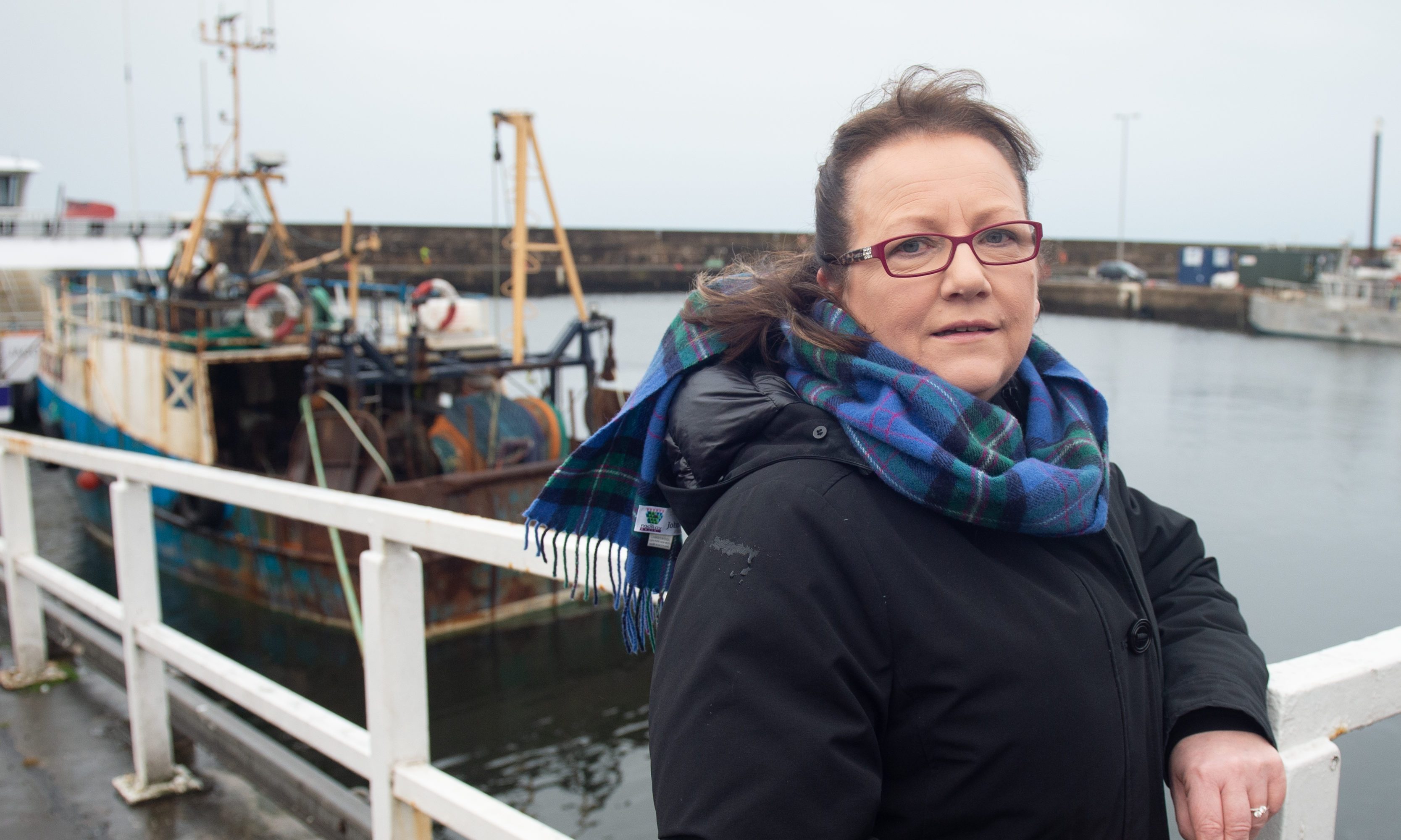 Sonya Warren leaning on railing at Buckie harbour. 