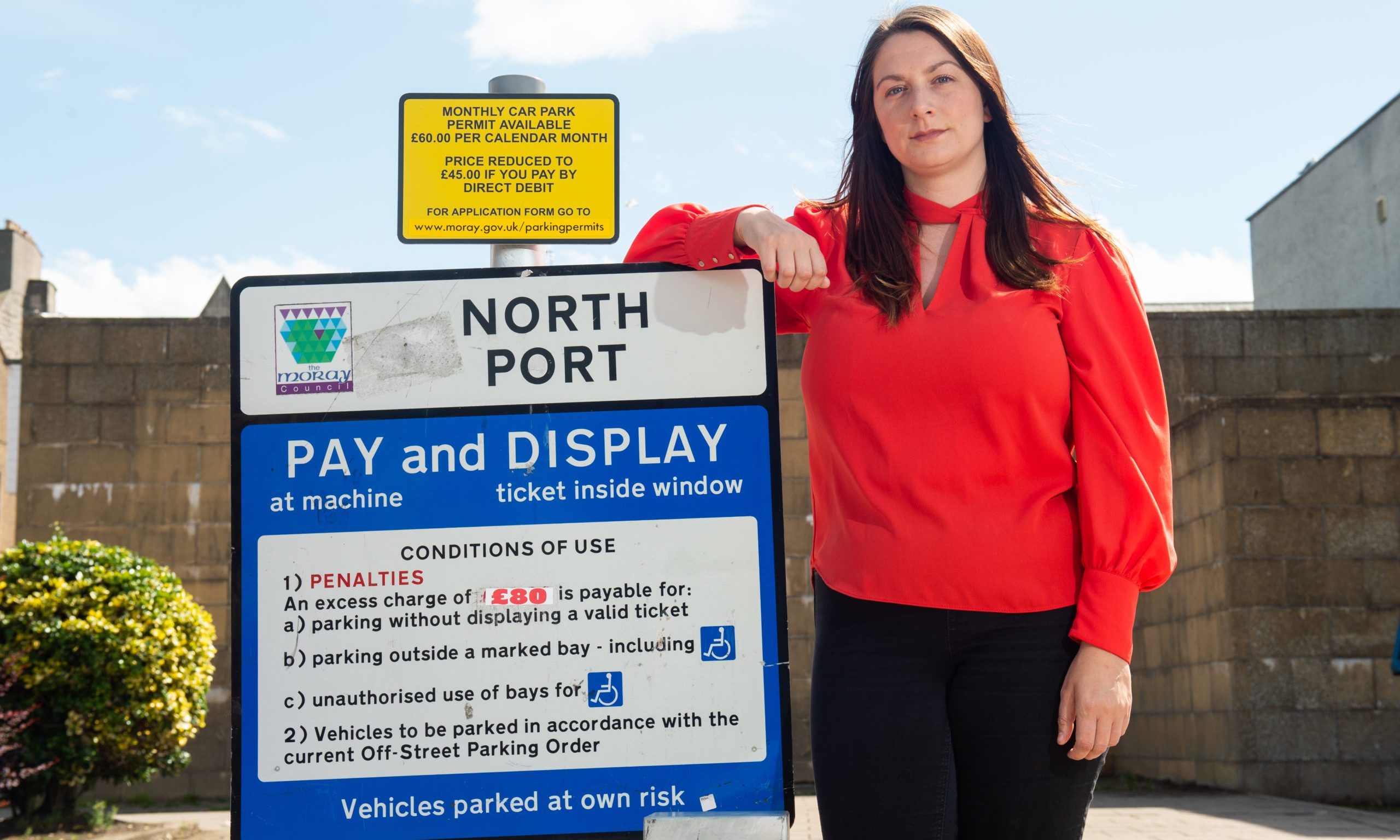 Sarah Medcraf at North Port parking sign. 