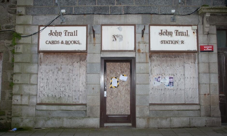 Image of the boarded up John Trail bookshop.