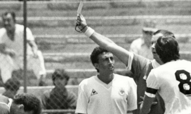 Joel Quiniou shows the red card to Uruguayan player Jose Batista for a bad tackle on Scotland's Gordon Strachan at the World Cup match between Scotland and Uruguay in 1986.