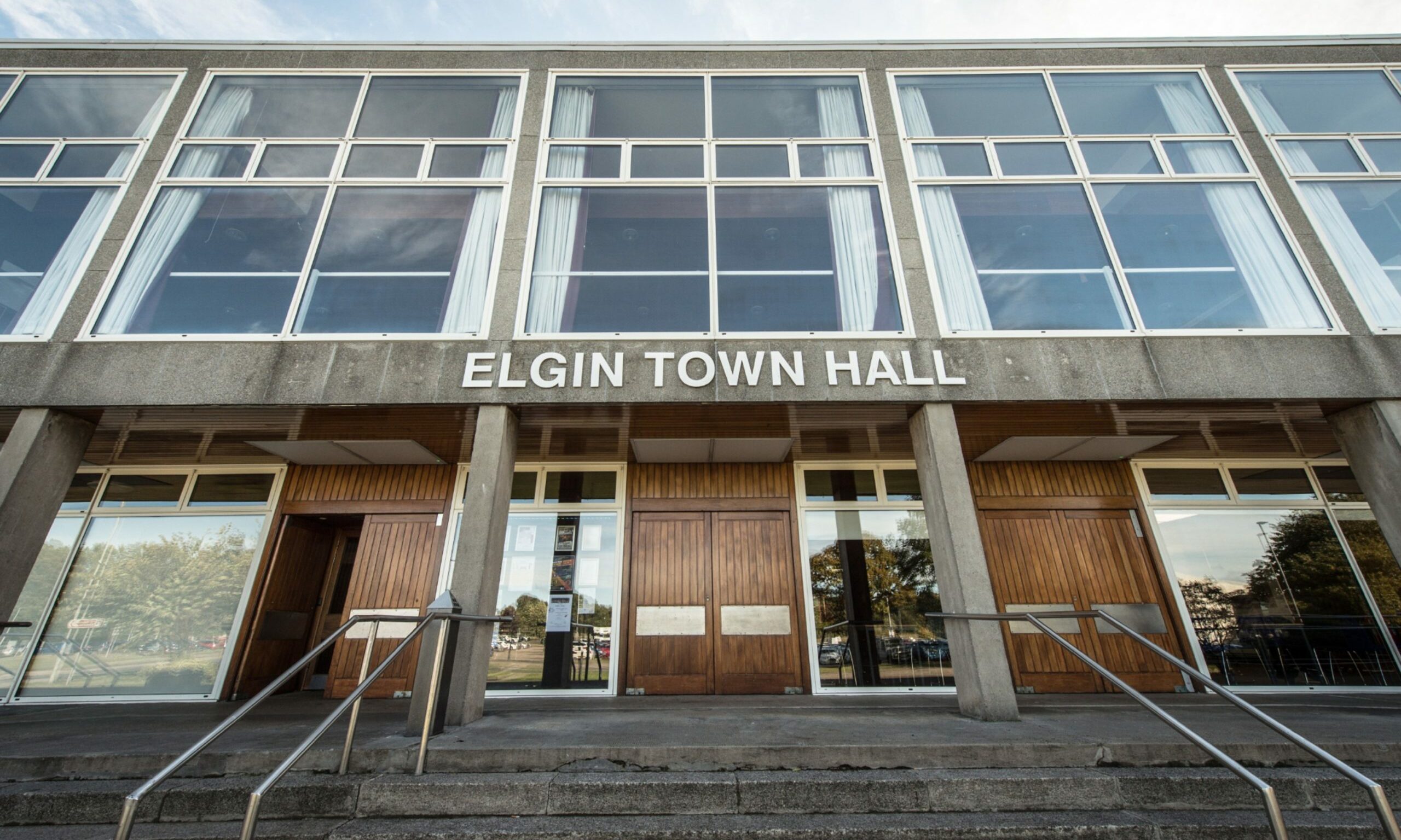 View of entrance to Elgin Town Hall from bottom of steps looking up at main sign. 