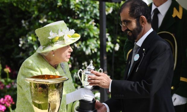 Britain's Elizabeth II presents Dubai's ruler Sheikh Mohammed bin Rashid al-Maktoum with a trophy for the winning owner of the 4.20 Diamond Jubilee Stake during the final day of Royal Ascot in Ascot, Britain, 22 June 2019.