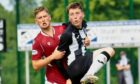 Elgin City forward Kane Hester is challenged by Arbroath's James Craigen.