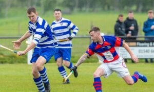 Fraser Mackintosh (Newtonmore) with Fraser Munro (Kingussie), right, in the MacTavish Cup semi-final in 2019. Image: Neil G Paterson.