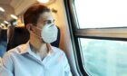 Train passenger wearing a face mask
