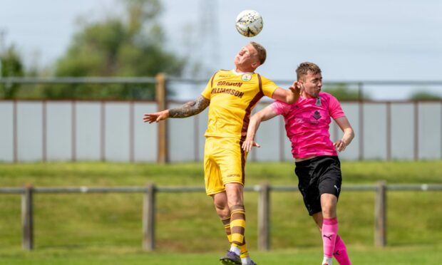 Forres Mechanics'  Lee Fraser competes for the ball with Inverness Caledonian Thistle's Ryan Fyffe in a summer 2021 friendly.