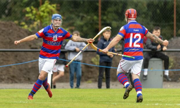 Kieran Macpherson (left) celebrates a goal for Kingussie.