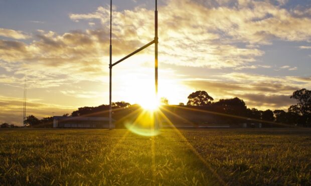 Goal posts for football, rugby union or league on field at sunset; Shutterstock ID 107464289; Purchase Order: -