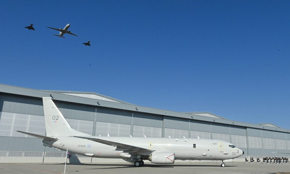 Poseidon plane in front of hangar during flypast. 