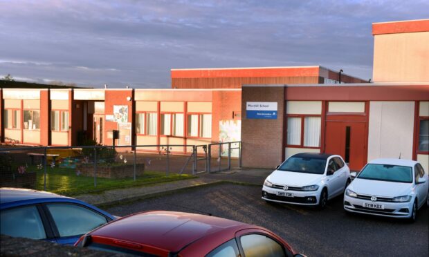 A picture of cars parked in front of Meethill School