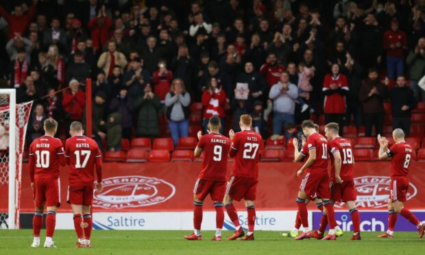 The Dons players applaud the fans at full-time after the cinch Premiership match between Aberdeen and Hibernian at Pittodrie.