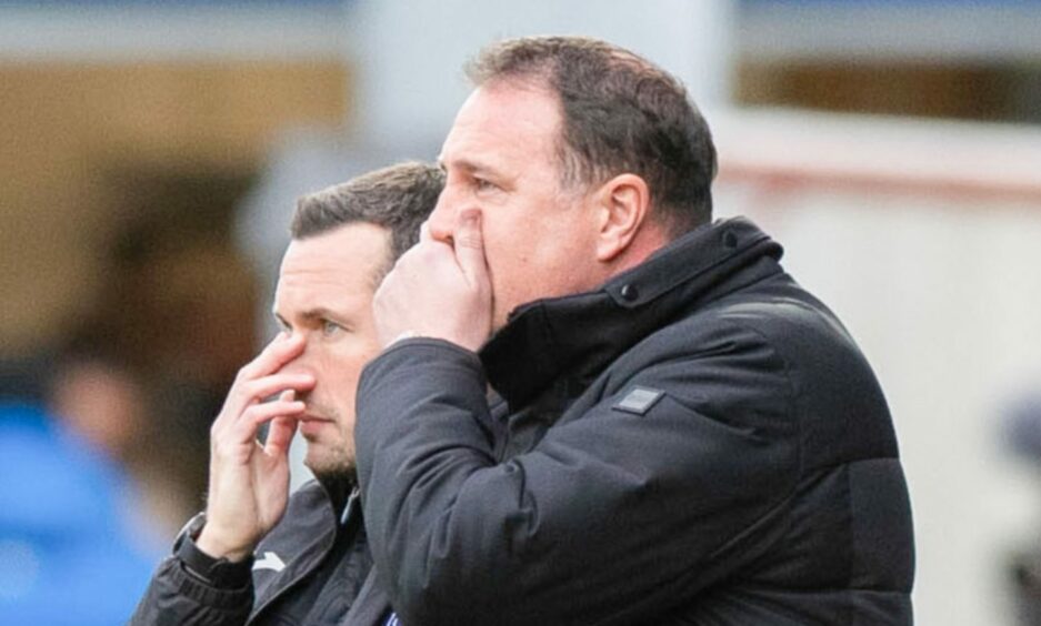 Don Cowie alongside Malky Mackay with their hands covering their mouths.