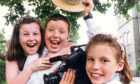 1992 - Chloe Morrison, left, and James Bell, both 8, are captured in happy mood by Katie Hurman after the school  won first prize in the annual Scottish Young Persons Video competition