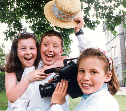 1992 - Chloe Morrison, left, and James Bell, both 8, are captured in happy mood by Katie Hurman after the school  won first prize in the annual Scottish Young Persons Video competition
