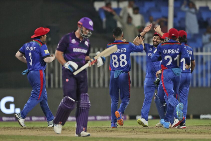 Afghanistan players celebrate the dismissal of Scotland batter George Munsey.