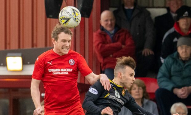 Ally MacDonald, left, in action for Brora Rangers against Albion Rovers in the Scottish Cup second round tie at Dudgeon Park.